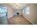 Inviting living room features a brick fireplace, wood-look floors and ample natural light at 6520 Chickasaw Dr, Douglasville, GA 30135