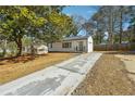 Ranch home with a long driveway and mature trees at 1770 Lee St, Decatur, GA 30035