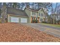 Green two-story house with a three-car garage and a sloping driveway at 2105 Cornerstone Sw Ln, Marietta, GA 30064