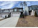 New construction townhomes with light brick, light grey paint, and two car garages at 2113 Garden Pl, Atlanta, GA 30316