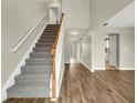 View of a carpeted staircase and hardwood floors in the entryway at 415 Gresham Dr, Stockbridge, GA 30281