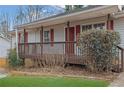 House exterior featuring a wooden deck and red front door at 4179 White Rd, Snellville, GA 30039