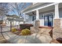 Inviting front porch with brick columns, a ceiling fan, and comfortable seating at 1559 Walker Ave, College Park, GA 30337