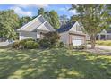 House exterior showcasing a well-maintained lawn and landscaping at 1855 Charleston Oak Cir, Lawrenceville, GA 30043