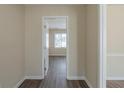 Hallway with neutral walls and modern flooring leading to a sunlit room at 1890 Old Concord Se Dr, Covington, GA 30016