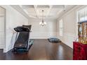 Formal dining room with hardwood floors, coffered ceiling, and chandelier at 5615 Cowles Cir, Suwanee, GA 30024