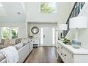 Bright foyer with hardwood floors, a sitting area to the left, and a staircase to the right at 1164 Pine Grove Dr, Alpharetta, GA 30009