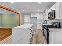 Bright kitchen features white cabinets, quartz counters, and a modern, stainless steel appliance at 6467 Joanna St, Lithia Springs, GA 30122