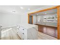The spacious kitchen features a large island with quartz countertops and white cabinetry at 6467 Joanna St, Lithia Springs, GA 30122