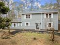 Two-story gray house with white shutters, stone accents, and landscaping at 3570 Knoll Crest Trl, Buford, GA 30519