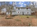 Two story gray house with white shutters and stone landscaping at 3570 Knoll Crest Trl, Buford, GA 30519