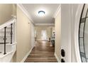 Inviting foyer featuring wood flooring and an elegant staircase with black metal spindles at 3570 Knoll Crest Trl, Buford, GA 30519