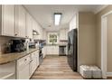 Bright kitchen features stainless appliances, granite counters, and white cabinetry at 3570 Knoll Crest Trl, Buford, GA 30519
