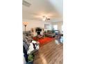 Spacious living room showcasing hard surface floors, a ceiling fan and neutral tones at 11118 Benton Woods Dr, Covington, GA 30014