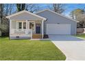 Gray house with white garage door, front porch, and landscaped lawn at 2195 Springdale Sw Rd, Atlanta, GA 30315