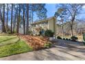 Green house with a driveway and a lake view in the background at 1925 Annwicks Dr, Marietta, GA 30062