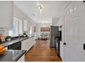 Modern kitchen with white cabinets, hardwood floors, and stainless steel appliances at 2124 Berryhill Se Cir, Smyrna, GA 30082