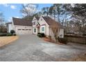 House exterior showcasing a three-car garage and driveway at 3210 Garmon Oak Trl, Lawrenceville, GA 30044