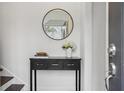 Bright entryway features a console table, mirror, and fresh flowers at 1992 Walthall Nw Dr, Atlanta, GA 30318