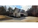 Brick house with a large driveway and attached garage at 213 Cades Ct, Mcdonough, GA 30252