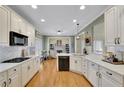 Spacious kitchen with white cabinets, marble countertops, and hardwood floors at 4760 Green Summers Dr, Cumming, GA 30028