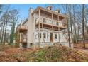 View of the side of a two-story home with unfinished construction, wooden balconies, and large bay windows at 3160 Hathaway Ct, Atlanta, GA 30341