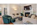 Cozy living room featuring hardwood floors, comfortable seating, and a fireplace with a mounted television at 919 Ormewood Se Ave, Atlanta, GA 30316