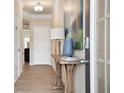 Light and airy foyer with wood-look flooring and a console table at 1149 Chastain Dr # 62, Sugar Hill, GA 30518