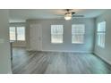 Bright living room featuring neutral walls and laminate flooring at 425 Camella Cir, Mcdonough, GA 30252