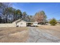 House with green roof and carport, large backyard and detached shed at 4785 Old Douglasville Rd, Lithia Springs, GA 30122