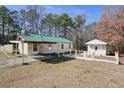 Ranch home with green metal roof and detached shed at 4785 Old Douglasville Rd, Lithia Springs, GA 30122