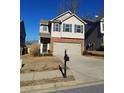 Two-story house with brick and siding exterior, two-car garage, and landscaping at 5138 Mcever View Dr, Sugar Hill, GA 30518