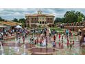 Community town square with a fountain, landscaping, and many people enjoying the area at 5138 Mcever View Dr, Sugar Hill, GA 30518