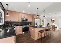 Modern kitchen features stainless steel appliances, a kitchen island with barstool seating, and modern lighting at 1956 Gober Se Ave, Smyrna, GA 30080