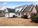 Two-story house with white siding and a brick accent wall at 23 Spring Folly Nw, Cartersville, GA 30121