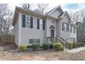 Side view of a charming two-story house with gray siding and black shutters at 6982 Springwood Dr, Douglasville, GA 30135