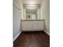 Bathroom with granite countertop and dark wood floor at 1635 River Main Ct, Lawrenceville, GA 30044