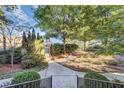 Landscaped courtyard with trees, shrubs, and walkways at 3633 Habersham Rd, Atlanta, GA 30305