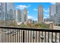 Balcony view showcasing the surrounding cityscape with modern buildings against a blue sky at 1075 Peachtree Ne Walk # A421, Atlanta, GA 30309