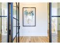 Bright and airy foyer with hardwood floors, black metal doors, and large framed art at 2624 Forrest Ne Way, Atlanta, GA 30305