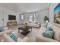 Spacious living room with light sofas and a large TV at 337 Theodore Cox Cir, Canton, GA 30114