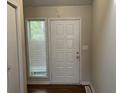Front entry with white door and wood flooring at 3763 Woodrose Ct, Snellville, GA 30039
