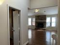Bright living room with hardwood floors and a stone fireplace at 3763 Woodrose Ct, Snellville, GA 30039