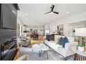 Bright open-concept living room features hardwood floors, a modern fireplace, and ample seating at 1732 Beecher Nw St, Atlanta, GA 30310