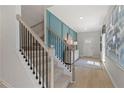 Modern staircase with black metal railing and light wood flooring at 19 Camellia Dr, Fairburn, GA 30213