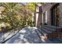 Exterior view of the brick home, showing the stone patio and wrought iron railing at 2515 Habersham Nw Rd, Atlanta, GA 30305