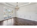Formal dining room with hardwood floors and wainscoting at 1078 Meadow Brook Dr, Woodstock, GA 30188