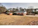 Ranch house with a large yard and wooded backdrop at 879 Old Tucker Rd, Stone Mountain, GA 30087