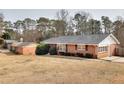 Brick ranch house with a large yard and mature trees at 879 Old Tucker Rd, Stone Mountain, GA 30087