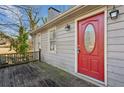 Red front door with glass accents and wooden deck at 1058 Hickory Rd, Canton, GA 30115